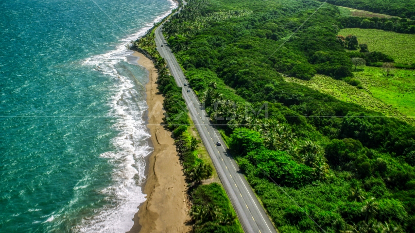 A Caribbean island beach and highway in Dorado, Puerto Rico Aerial Stock Photo AX101_225.0000241F | Axiom Images