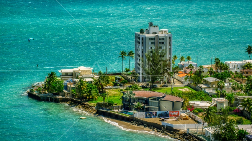 Oceanfront homes and a kite surfer in San Juan, Puerto Rico Aerial Stock Photo AX102_007.0000151F | Axiom Images