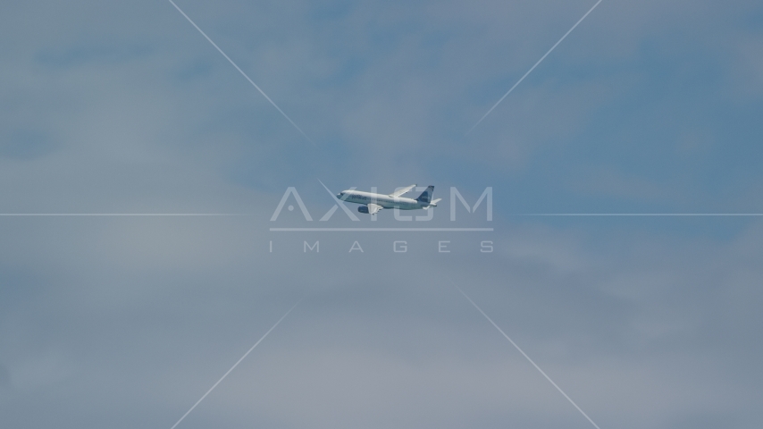 A passenger jet flying over Carolina, Puerto Rico Aerial Stock Photo AX102_013.0000134F | Axiom Images