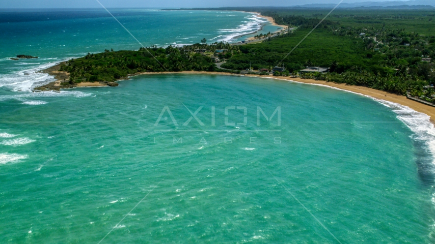 Clear turquoise waters by the beach and homes in Loiza, Puerto Rico  Aerial Stock Photo AX102_016.0000216F | Axiom Images