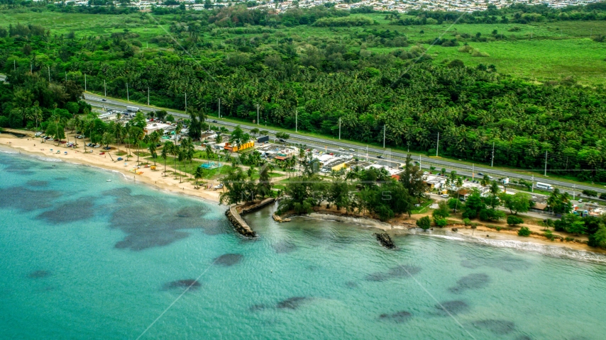 Highway and beachfront shops and restaurants in Luquillo, Puerto Rico  Aerial Stock Photo AX102_048.0000000F | Axiom Images