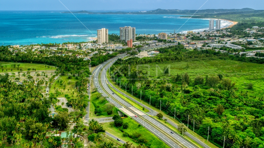 Highway 3 and a beach community with condo complexes in Luquillo, Puerto Rico  Aerial Stock Photo AX102_048.0000244F | Axiom Images