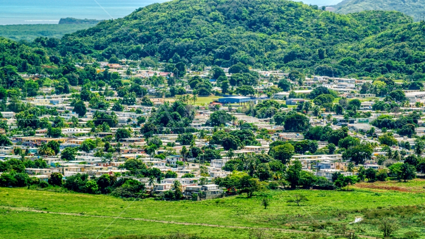 Homes beside tree covered hills, Fajardo, Puerto Rico  Aerial Stock Photo AX102_055.0000000F | Axiom Images