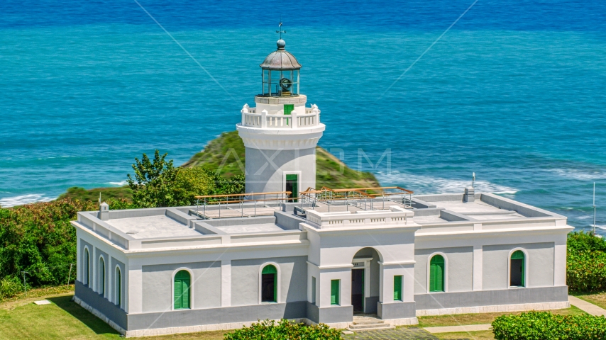 Cape San Juan Light looking out on to crystal blue waters, Puerto Rico Aerial Stock Photo AX102_066.0000000F | Axiom Images