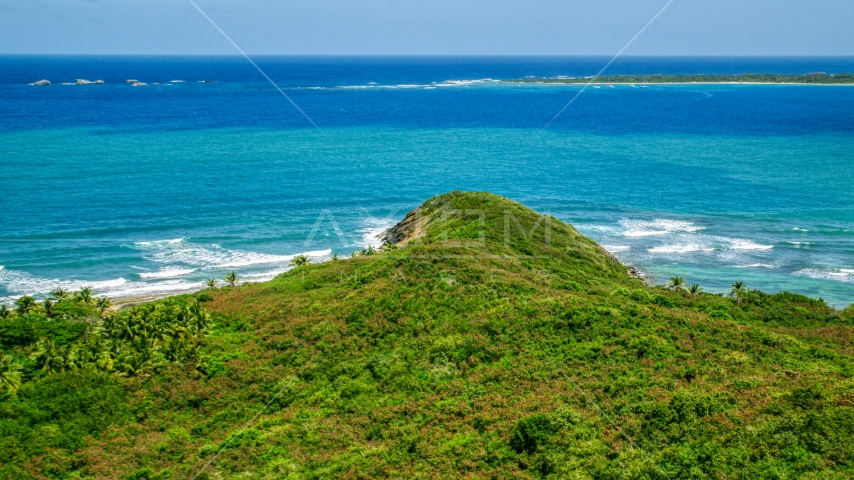 Green shore overlooking Caribbean ocean and tiny islands in Fajardo, Puerto Rico  Aerial Stock Photo AX102_071.0000000F | Axiom Images