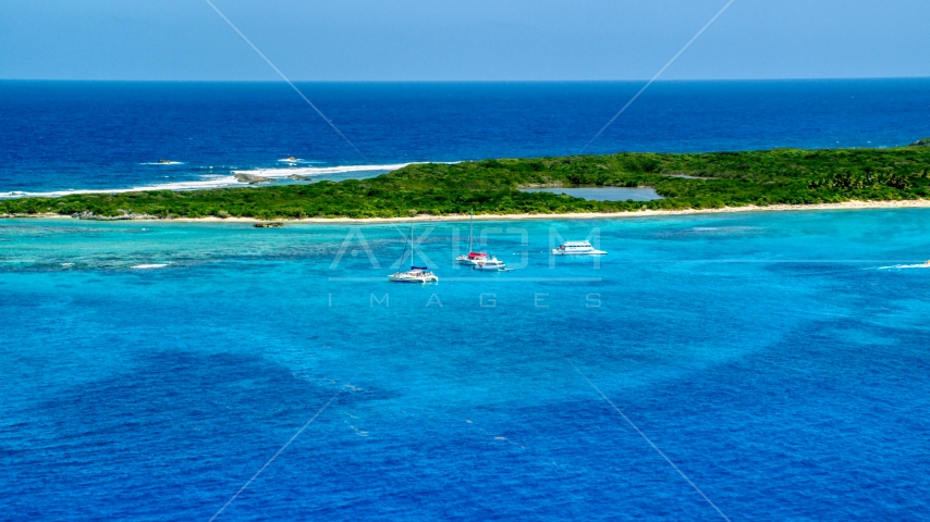 Catamarans near a Caribbean island in tropical blue waters, Rada Fajardo, Puerto Rico Aerial Stock Photo AX102_073.0000202F | Axiom Images