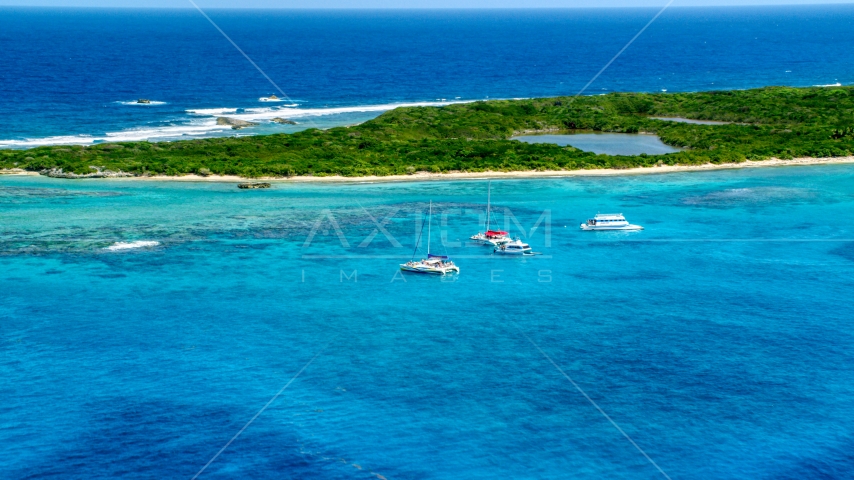 Catamarans in tropical blue waters near reefs and an island, Rada Fajardo, Puerto Rico Aerial Stock Photo AX102_074.0000000F | Axiom Images