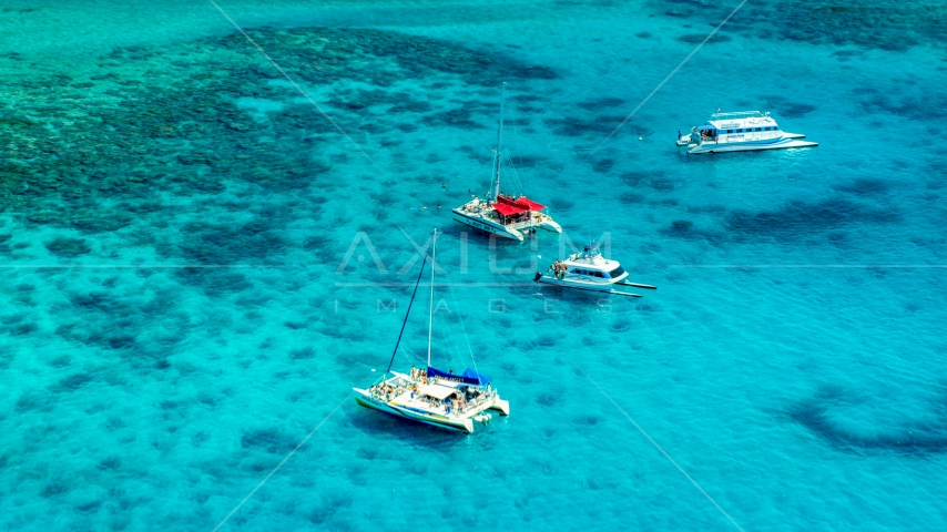Catamarans in tropical blue Caribbean waters near reefs in Rada Fajardo, Puerto Rico Aerial Stock Photo AX102_074.0000165F | Axiom Images