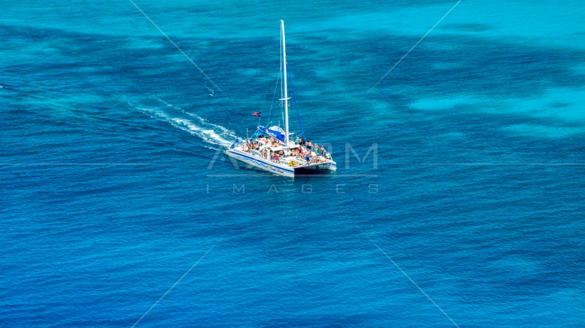A catamaran in crystal clear blue tropical waters, Rada Fajardo, Puerto Rico  Aerial Stock Photo AX102_076.0000000F | Axiom Images
