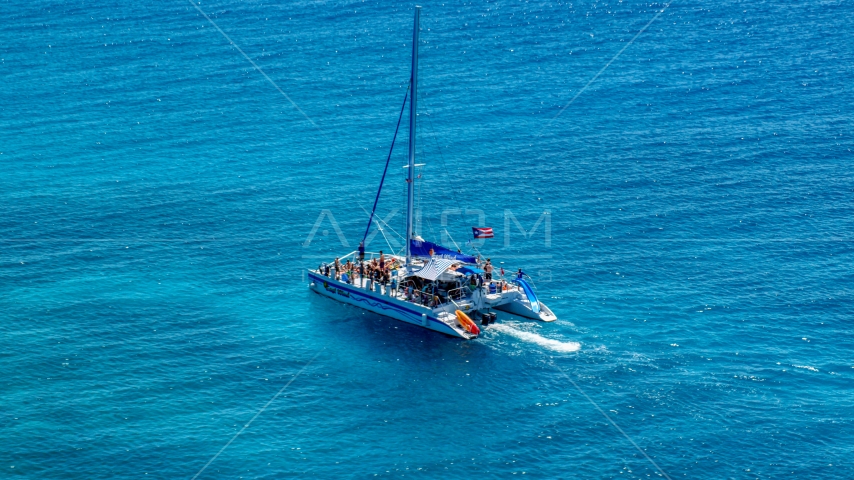 Catamaran with people in tropical blue water, Rada Fajardo, Puerto Rico Aerial Stock Photo AX102_077.0000141F | Axiom Images
