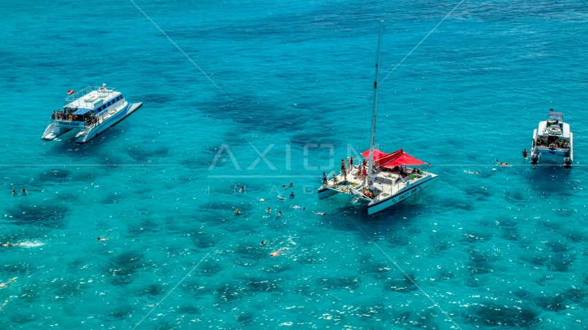 Snorkelers and catamarans in tropical blue waters, Rada Fajardo, Puerto Rico Aerial Stock Photo AX102_078.0000040F | Axiom Images