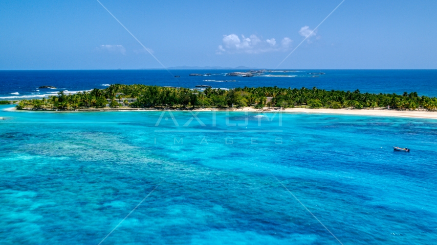 High above tropical blue waters near a small island, Puerto Rico  Aerial Stock Photo AX102_083.0000278F | Axiom Images