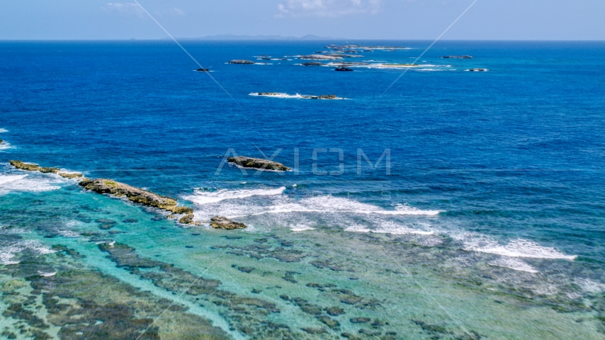 Rocks and waves in tropical blue waters, Puerto Rico  Aerial Stock Photo AX102_084.0000239F | Axiom Images