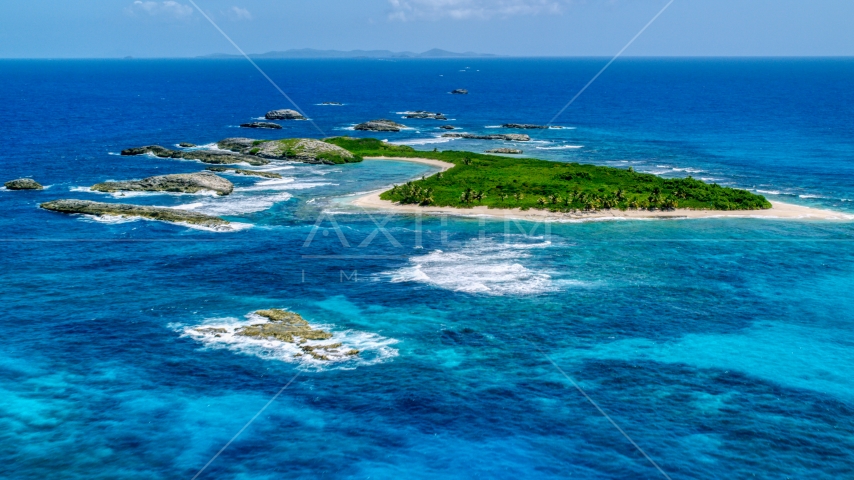 A green island surrounded by smaller rocky islands and tropical blue waters, Puerto Rico  Aerial Stock Photo AX102_088.0000259F | Axiom Images