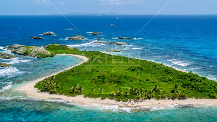 Tiny green island with beach in sapphire blue water, Puerto Rico  Aerial Stock Photo AX102_089.0000033F | Axiom Images