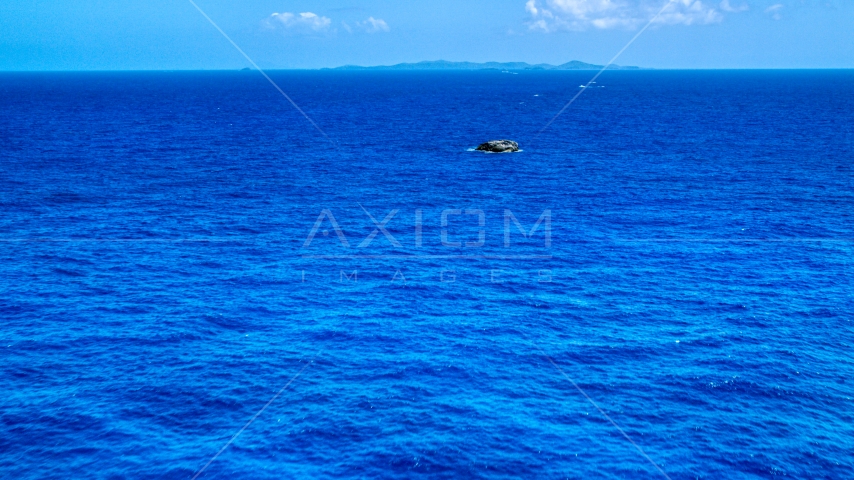 Tiny rocky island in sapphire blue ocean, Puerto Rico  Aerial Stock Photo AX102_090.0000165F | Axiom Images