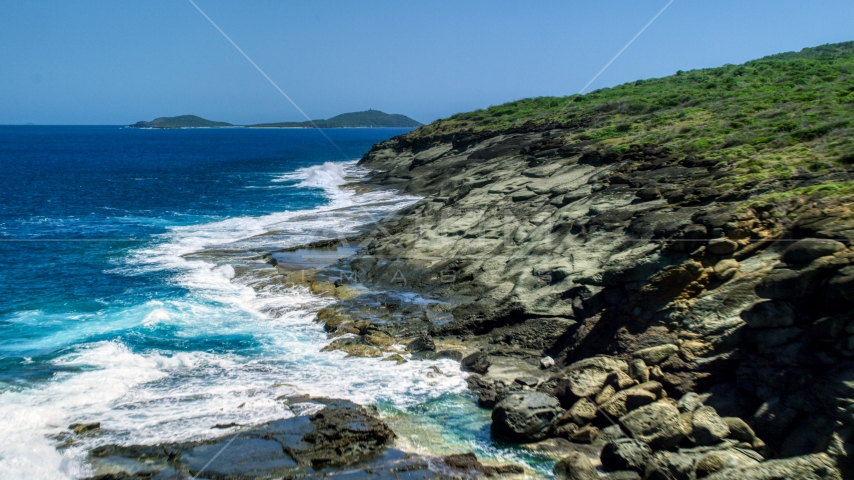 Waves crashing into a rugged island coast, Culebra, Puerto Rico Aerial Stock Photo AX102_126.0000234F | Axiom Images