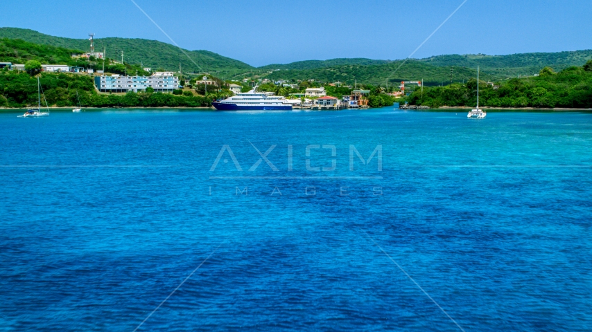 Ferry across a sapphire blue bay in Culebra, Puerto Rico  Aerial Stock Photo AX102_148.0000239F | Axiom Images