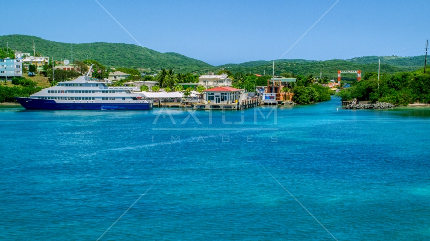 Ferry docked in sapphire waters by a waterfront town, and Culebra, Puerto Rico  Aerial Stock Photo AX102_150.0000000F | Axiom Images