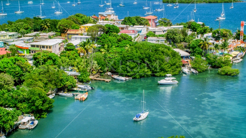 Boats docked at an island town on sapphire water, Culebra, Puerto Rico  Aerial Stock Photo AX102_151.0000138F | Axiom Images