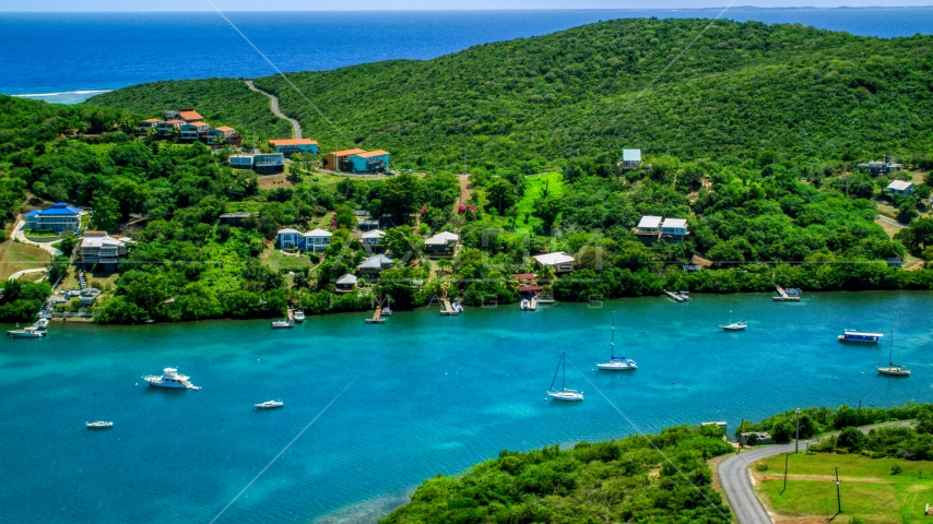 Oceanfront island homes by boats in sapphire waters, Culebra, Puerto Rico Aerial Stock Photo AX102_155.0000201F | Axiom Images