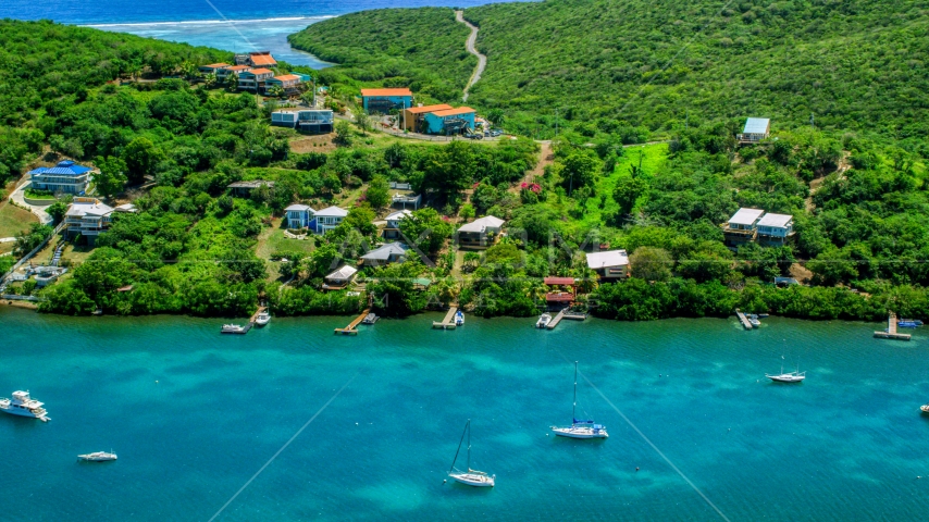 Island homes overlooking boats in the water in Culebra, Puerto Rico Aerial Stock Photo AX102_156.0000000F | Axiom Images