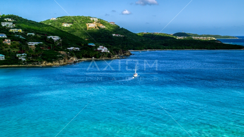 A sailboat near the Caribbean island coast with upscale homes, Southside, St Thomas  Aerial Stock Photo AX102_234.0000000F | Axiom Images