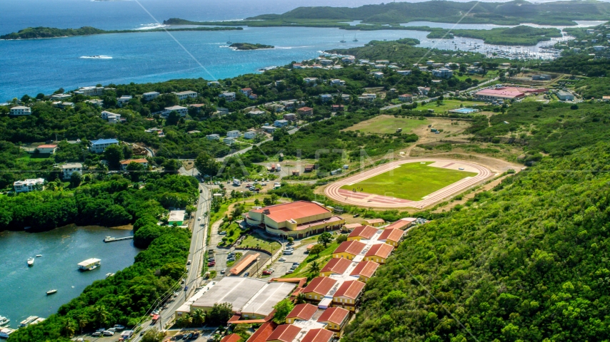 Island high school and track field near waterfront homes in East End, St Thomas, US Virgin Islands   Aerial Stock Photo AX102_244.0000000F | Axiom Images