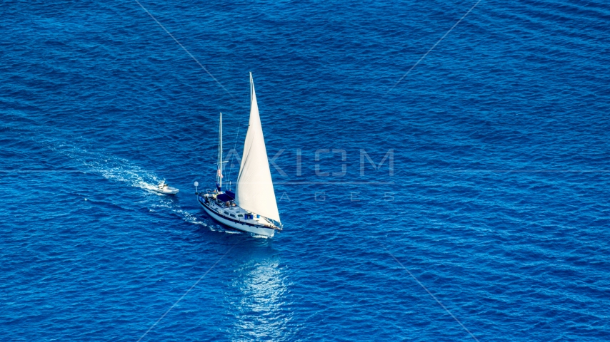 Sailboat in sapphire blue Caribbean waters, St Thomas, USVI  Aerial Stock Photo AX102_256.0000138F | Axiom Images