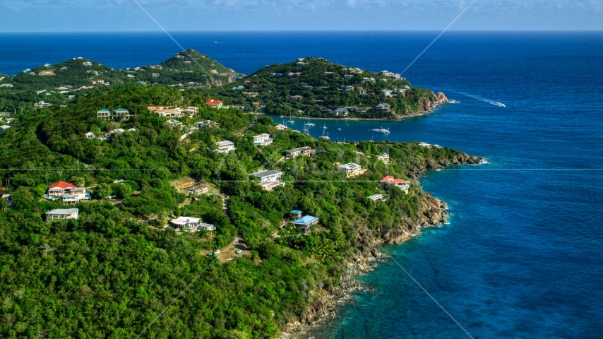 Hillside homes overlooking sapphire blue ocean waters, Cruz Bay, St John Aerial Stock Photo AX103_020.0000000F | Axiom Images