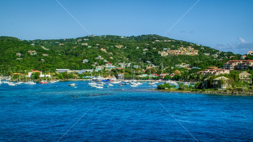Blue Caribbean waters in the harbor near hillside homes, Cruz Bay, St John Aerial Stock Photo AX103_029.0000072F | Axiom Images
