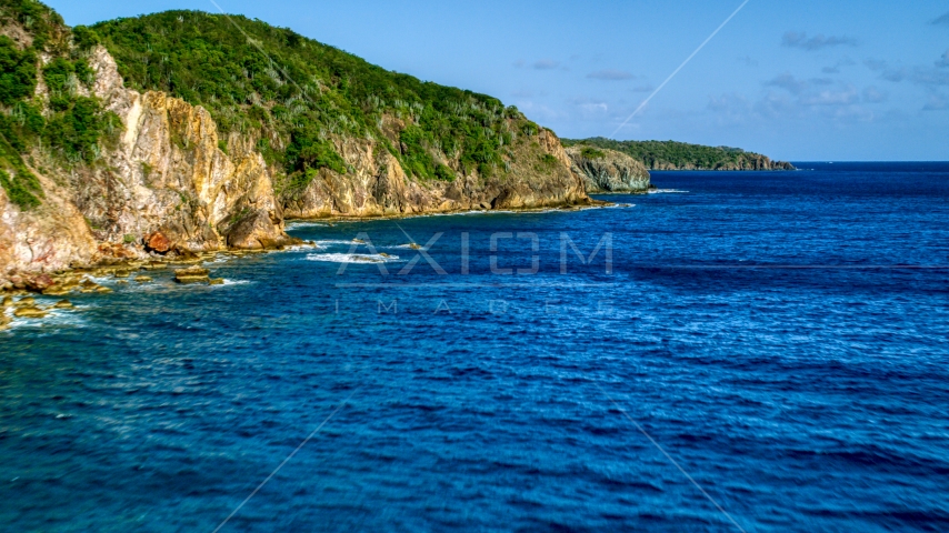 Coastal cliffs along sapphire blue Caribbean waters, Central, St John Aerial Stock Photo AX103_050.0000066F | Axiom Images