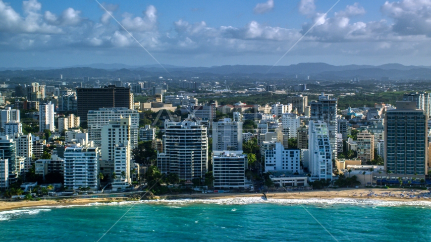 Beachfront condo complexes along Caribbean blue waters, San Juan, Puerto Rico Aerial Stock Photo AX103_150.0000114F | Axiom Images