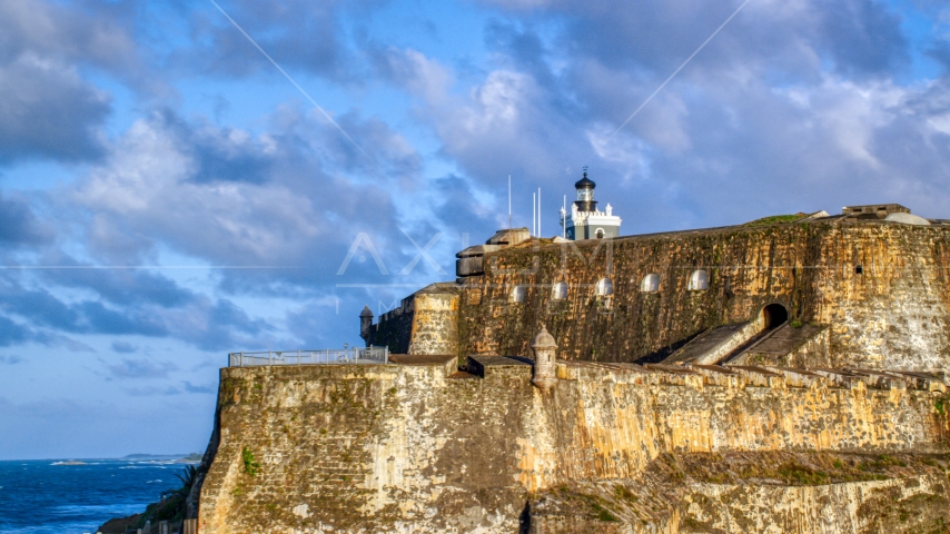 The steep walls and lighthouse of the Fort San Felipe del Morro, Old San Juan, sunset Aerial Stock Photo AX104_012.0000023F | Axiom Images