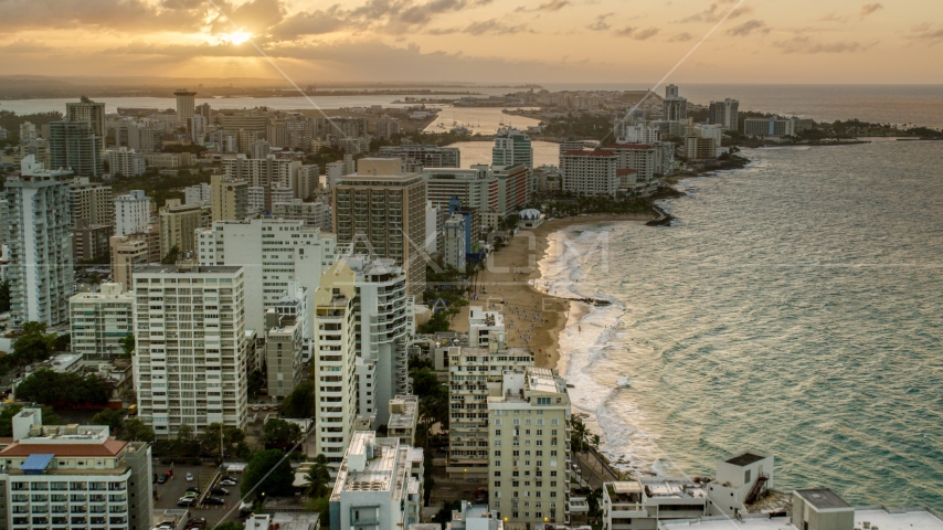 Beachfront hotels and ocean waters, San Juan, Puerto Rico, sunset Aerial Stock Photo AX104_068.0000000F | Axiom Images