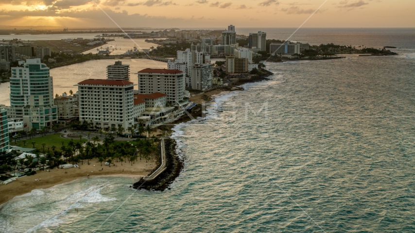 Beachfront Caribbean hotels along the ocean, San Juan, Puerto Rico, sunset Aerial Stock Photo AX104_070.0000000F | Axiom Images