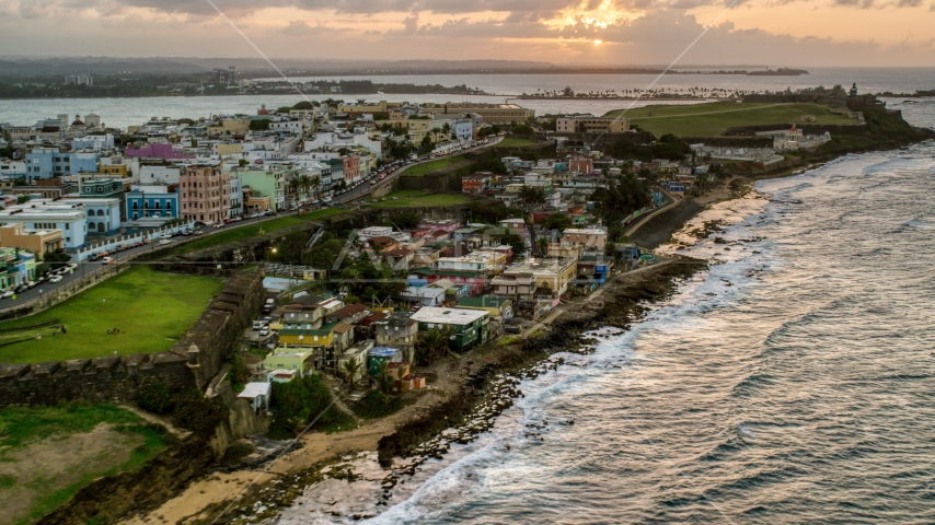 Oceanfront Caribbean homes, Old San Juan, Puerto Rico, sunset Aerial Stock Photo AX104_078.0000146F | Axiom Images