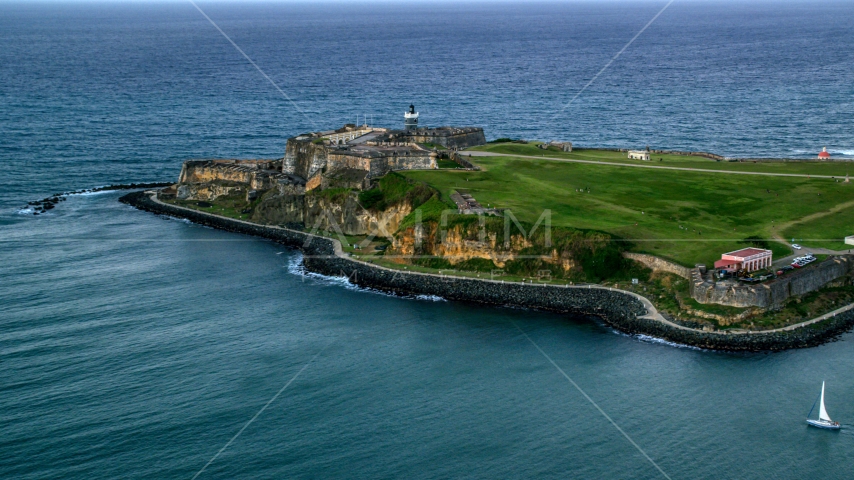 Fort San Felipe del Morro surrounded by Caribbean blue ocean waters, Old San Juan, twilight Aerial Stock Photo AX104_086.0000000F | Axiom Images
