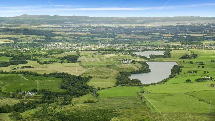 Green farm fields and a reservoir, Denny, Scotland Aerial Stock Photo AX109_004.0000000F | Axiom Images