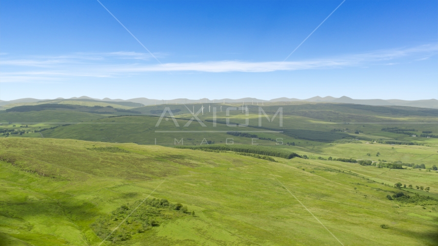 Hilltop windmills and farm fields in Denny, Scotland Aerial Stock Photo AX109_005.0000000F | Axiom Images