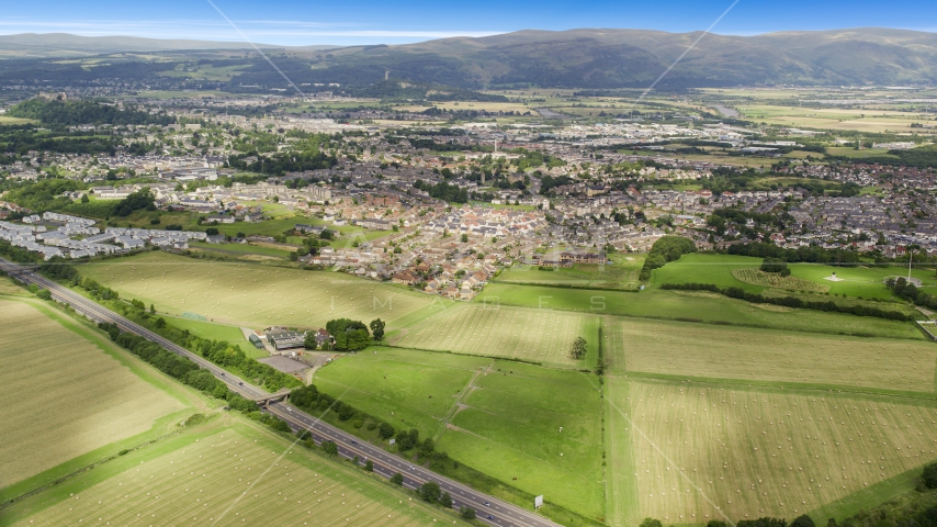 Farms and fields near rural homes, Stirling, Scotland Aerial Stock Photo AX109_013.0000176F | Axiom Images