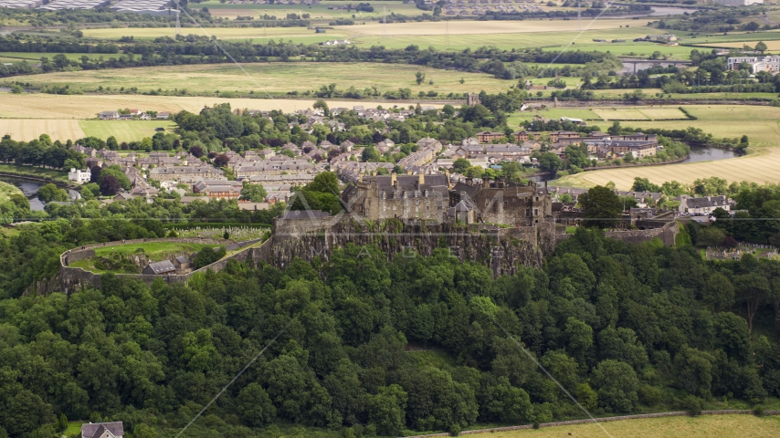 Hilltop Stirling Castle among trees, Scotland Aerial Stock Photo AX109_019.0000000F | Axiom Images