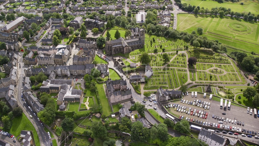 Church and cemetery by residential area, Stirling, Scotland Aerial Stock Photo AX109_026.0000189F | Axiom Images