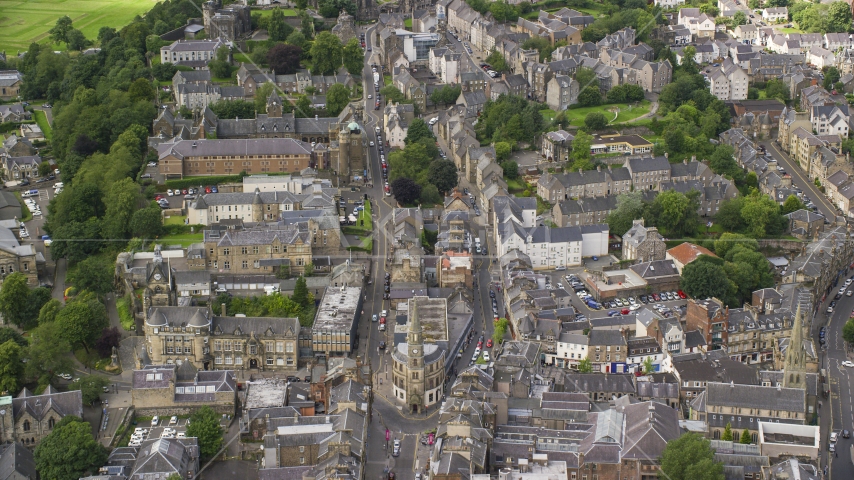 Apartment buildings and shops by city streets in Stirling, Scotland Aerial Stock Photo AX109_032.0000000F | Axiom Images