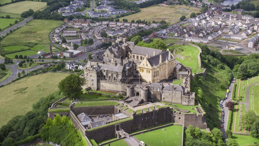 Historic Stirling Castle on a hill in Scotland Aerial Stock Photo AX109_035.0000118F | Axiom Images