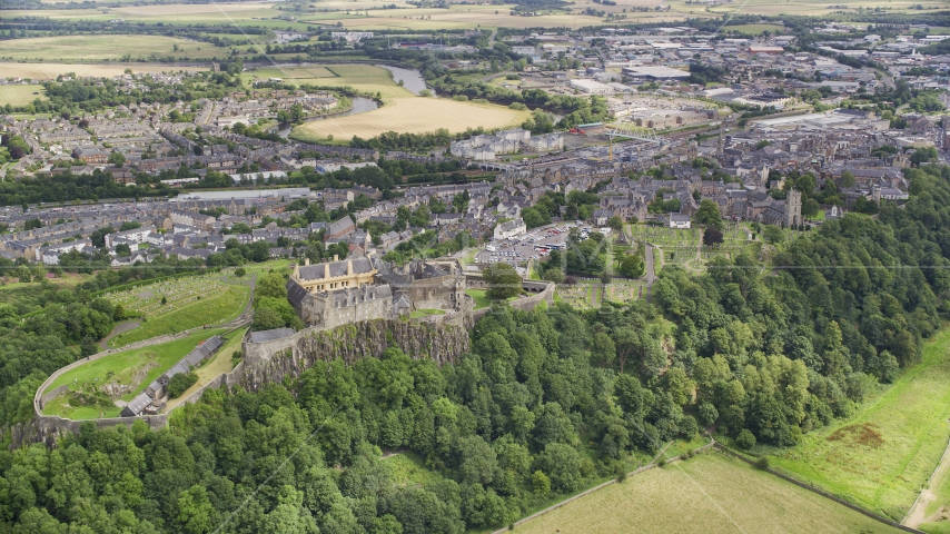 Stirling Castle on a tree covered hill, Scotland Aerial Stock Photo AX109_037.0000000F | Axiom Images