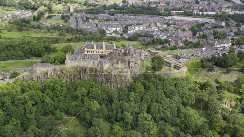 Stirling Castle atop a hill covered with trees, Scotland Aerial Stock Photo AX109_038.0000000F | Axiom Images