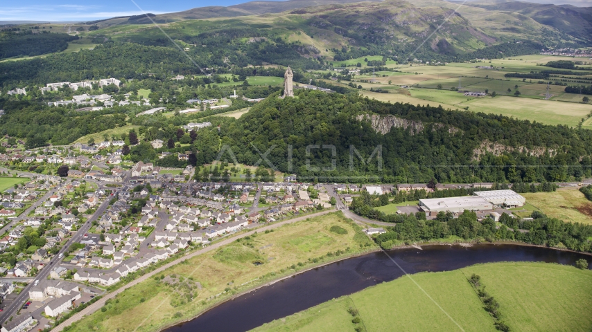 This historic Wallace Monument surrounded by trees, Stirling, Scotland Aerial Stock Photo AX109_046.0000133F | Axiom Images