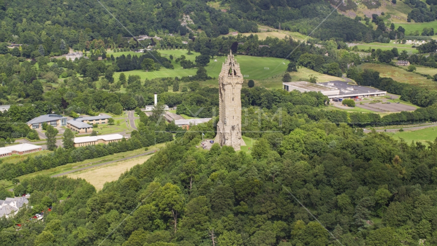 Wallace Monument and hilltop trees, Stirling, Scotland Aerial Stock Photo AX109_048.0000000F | Axiom Images