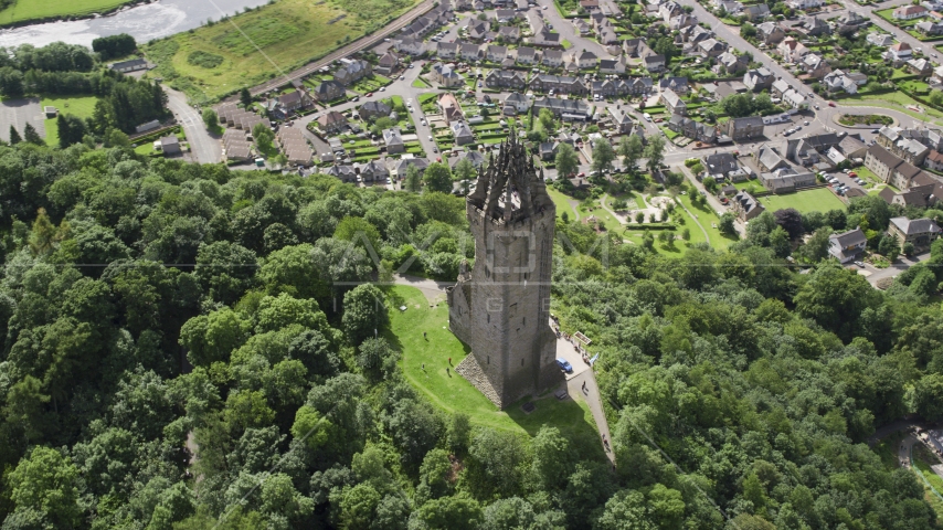 The historic Wallace Monument with a view of Stirling, Scotland Aerial Stock Photo AX109_051.0000142F | Axiom Images